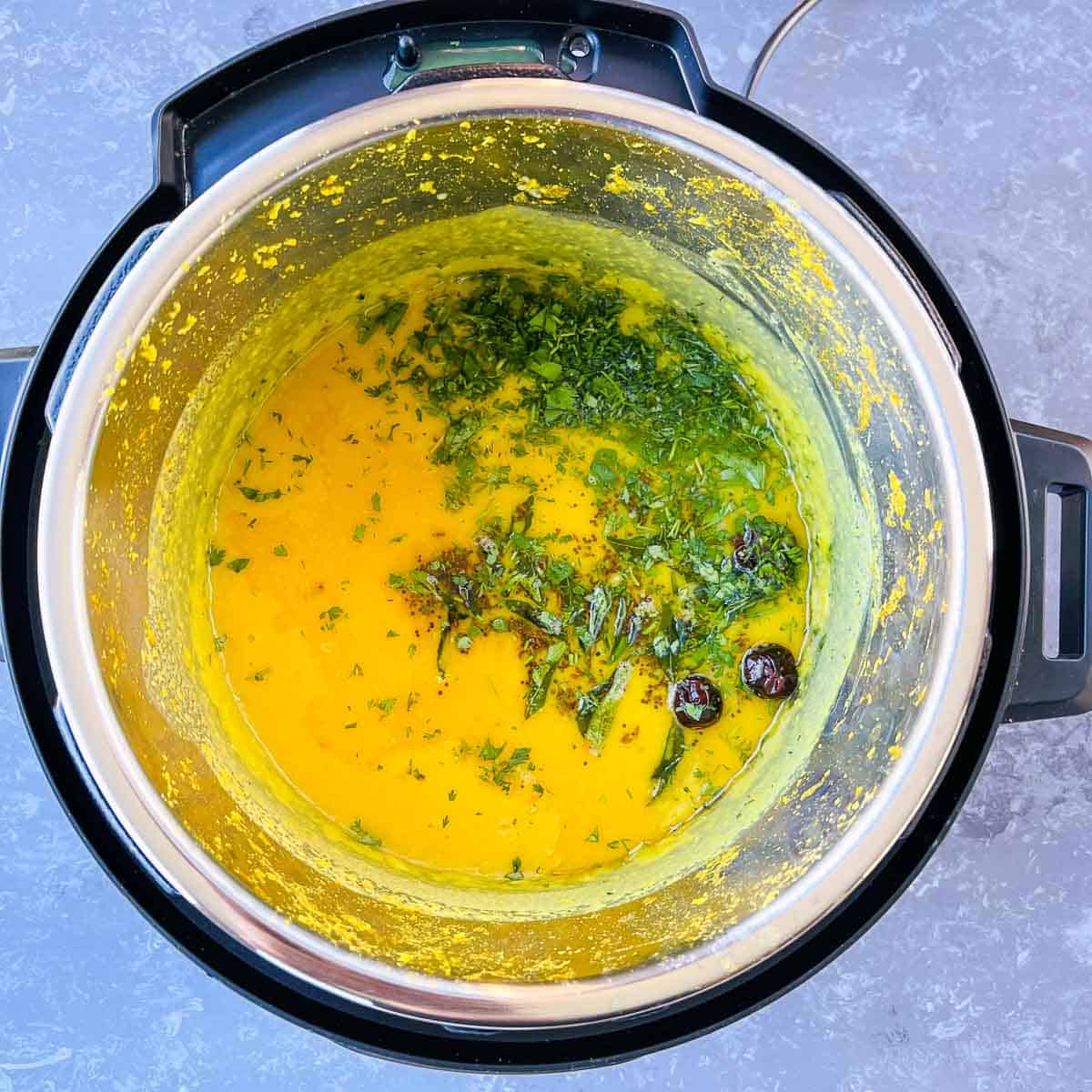 Cilantro and lemon juice garnish on the dal in Instant Pot.
