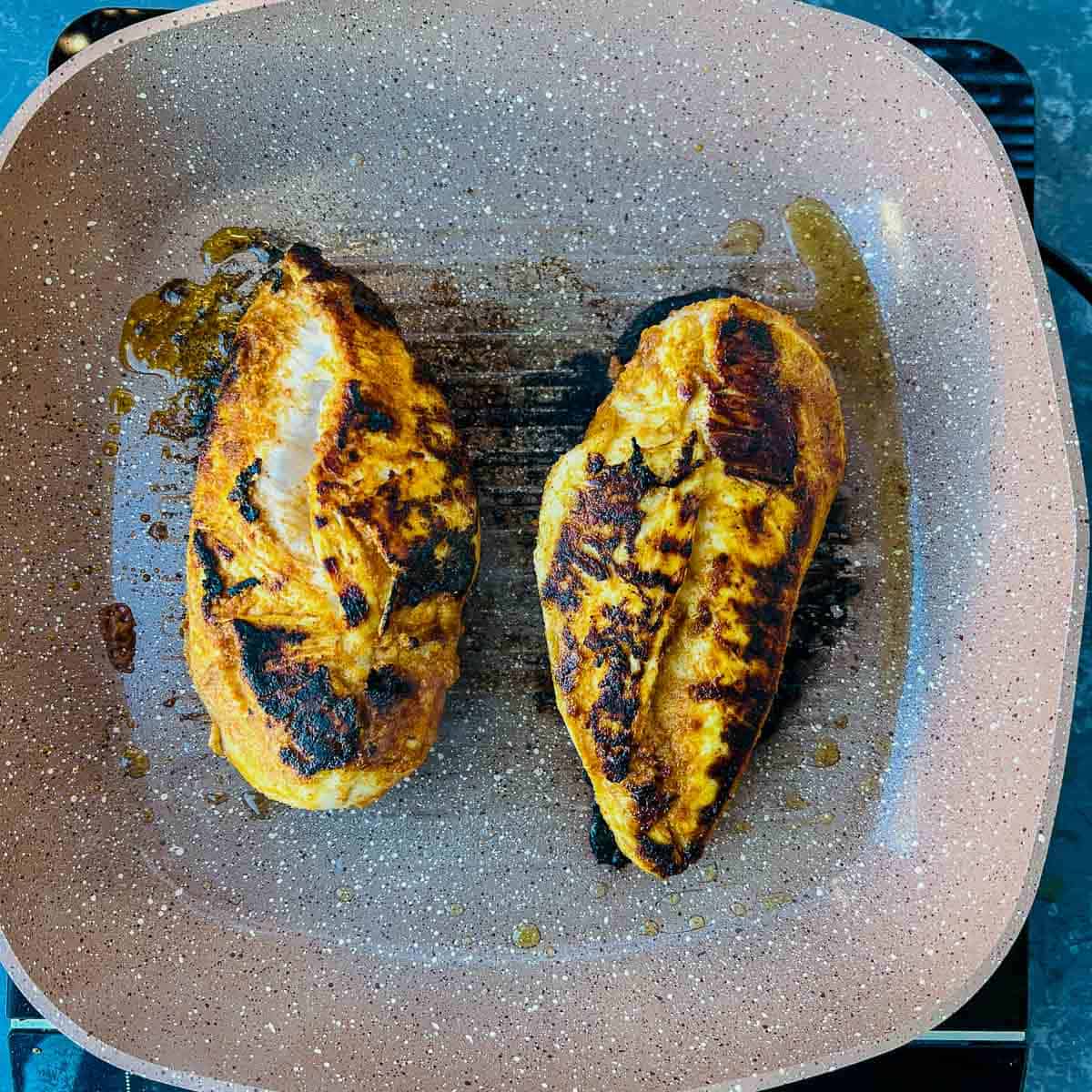 Chicken cooked on a grill pan.