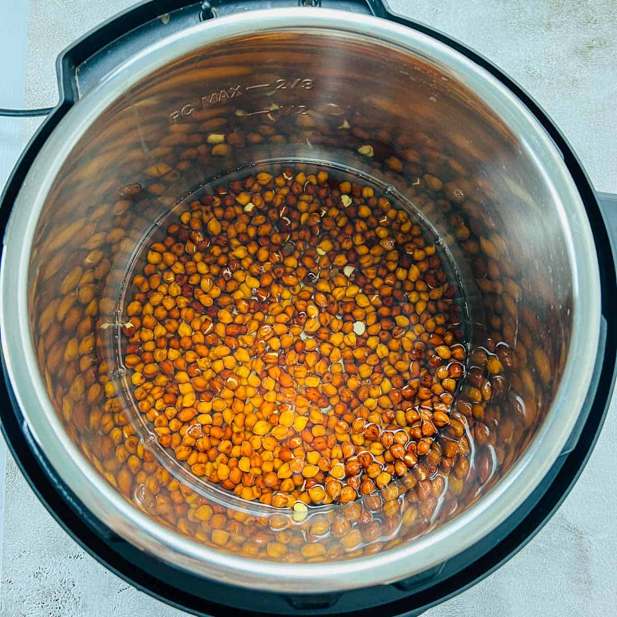 Soaked black chickpeas and water in Instant Pot.