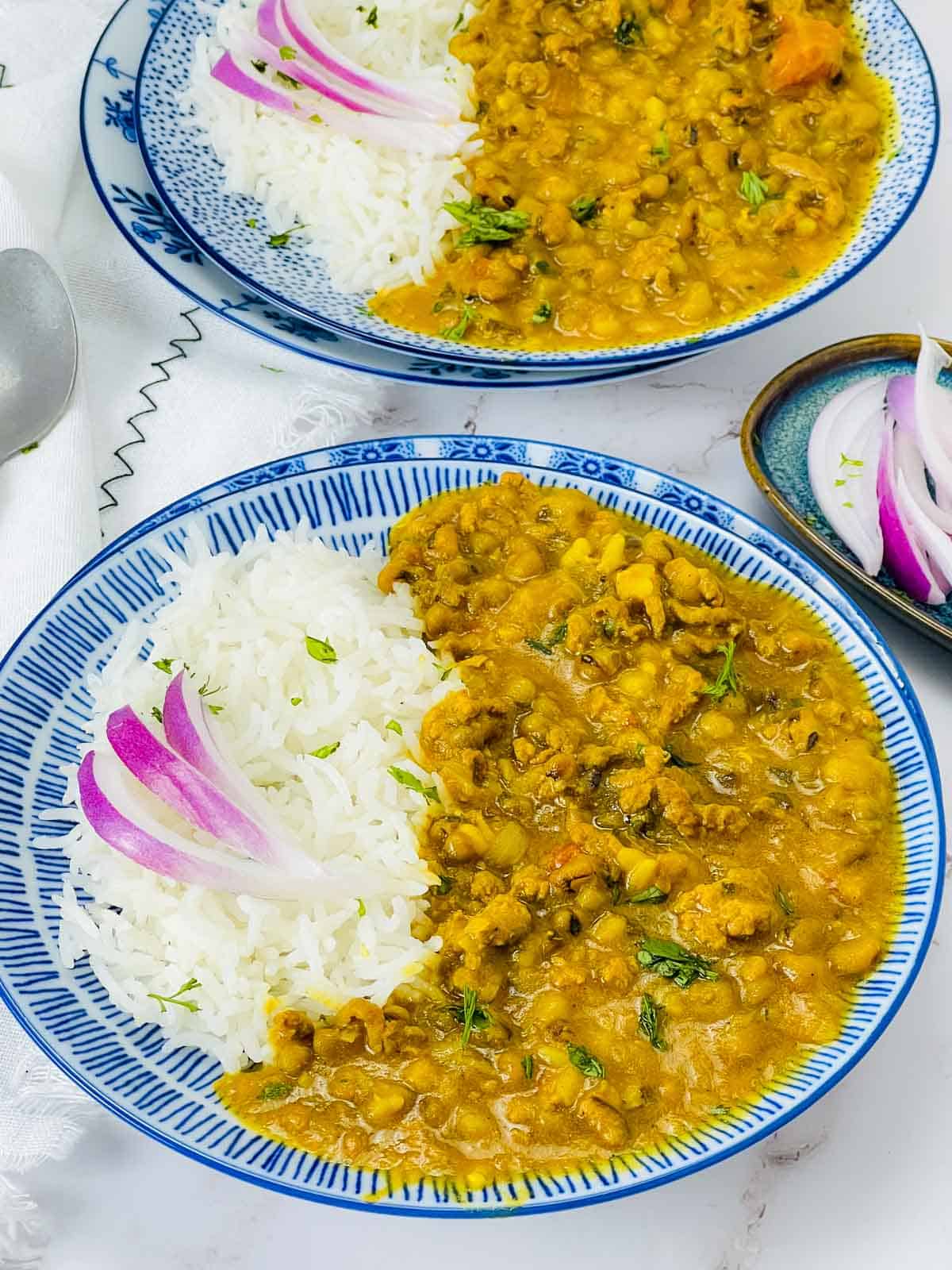 Keema green moong dal with rice on blue plate.