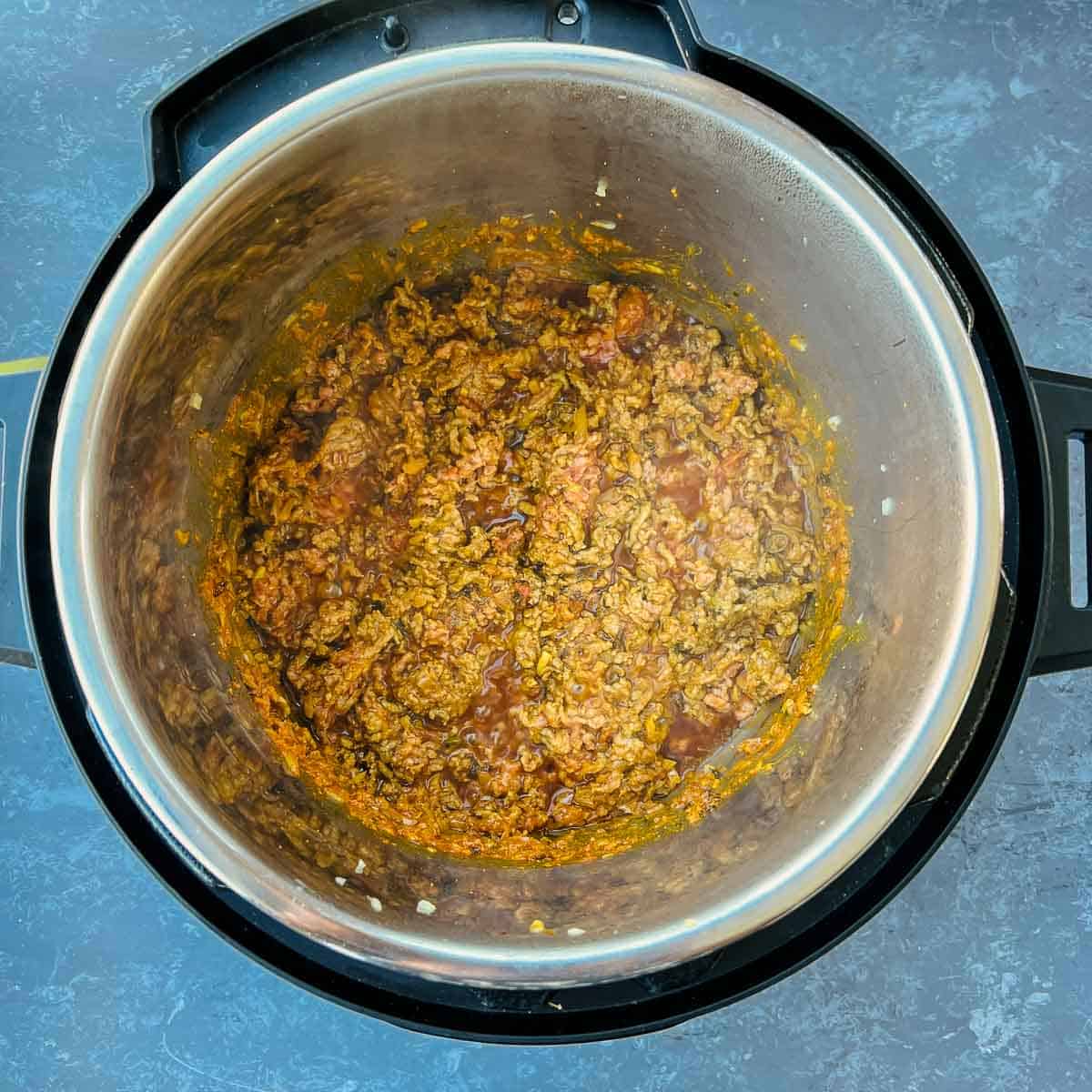 Browned ground meat with tomato masala in Instant Pot.