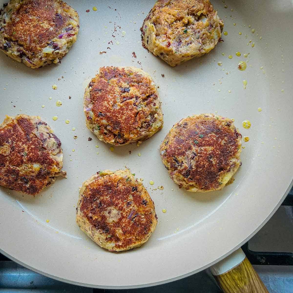 Cooked patties in a frying pan.