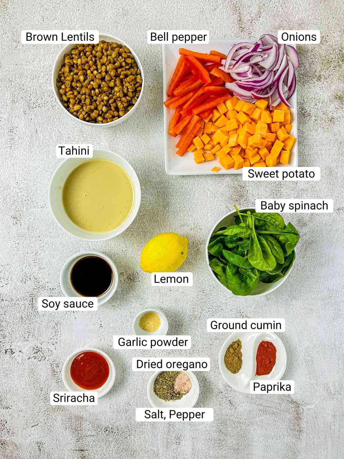 Ingredients to make lentil buddha bowl on a white surface.