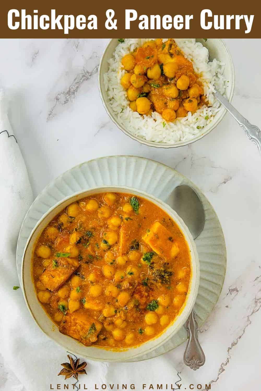 Chickpea paneer curry in a white bowl with rice bowl in the background.
