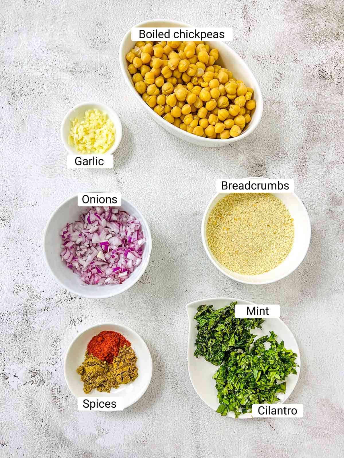 Ingredients to make chickpea nuggets on a white surface.