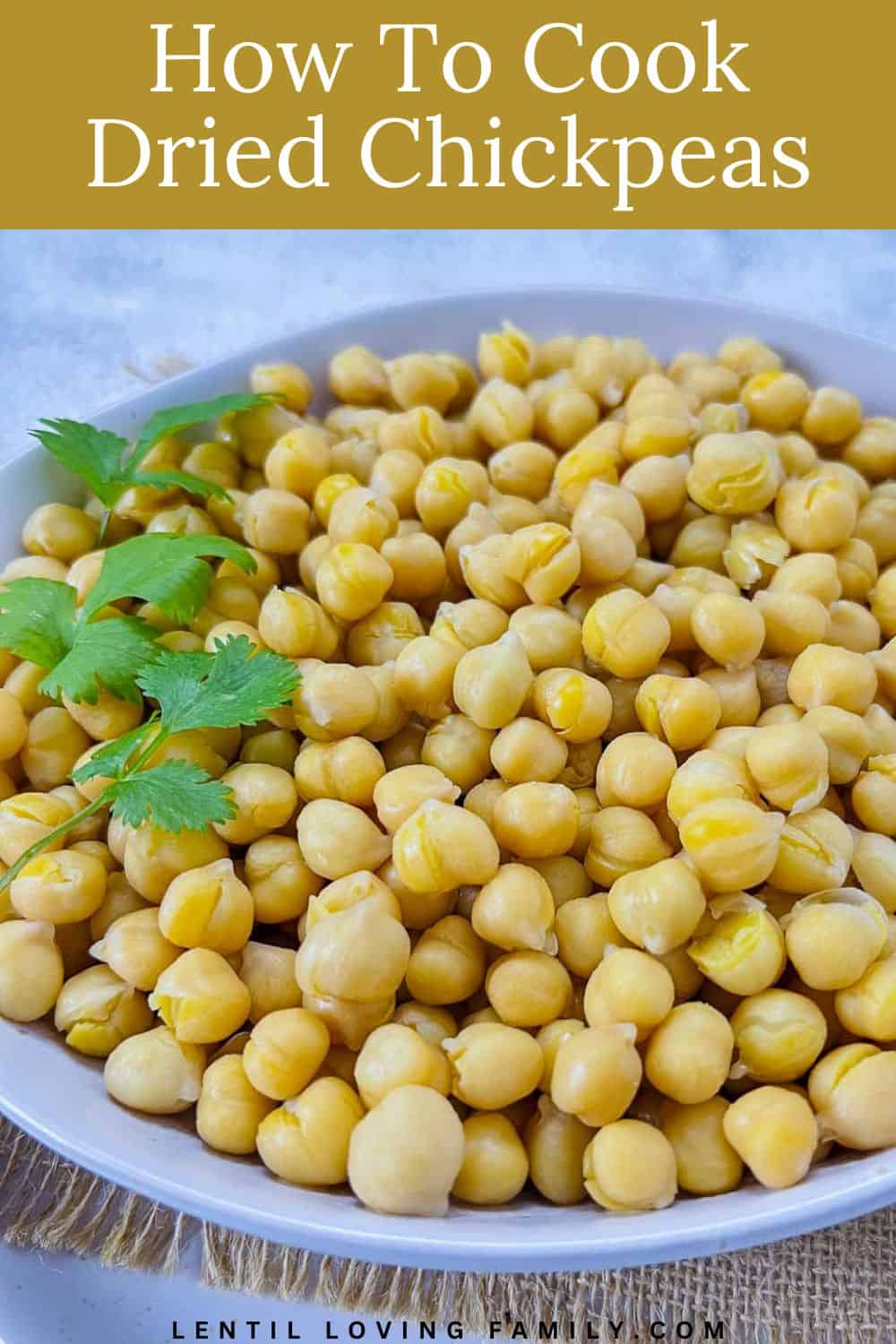 Cooked chickpeas topped with cilantro and placed in a white bowl.