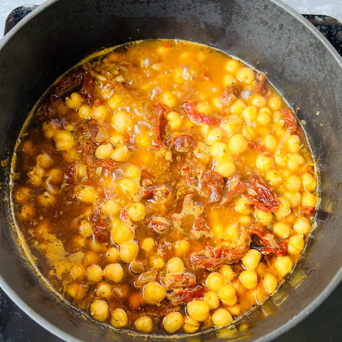 Chickpeas and spices simmering in Dutch oven.
