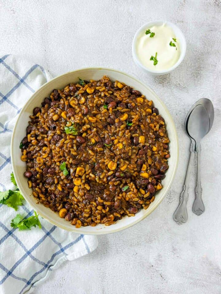 Mexican rice and beans served with sour cream.