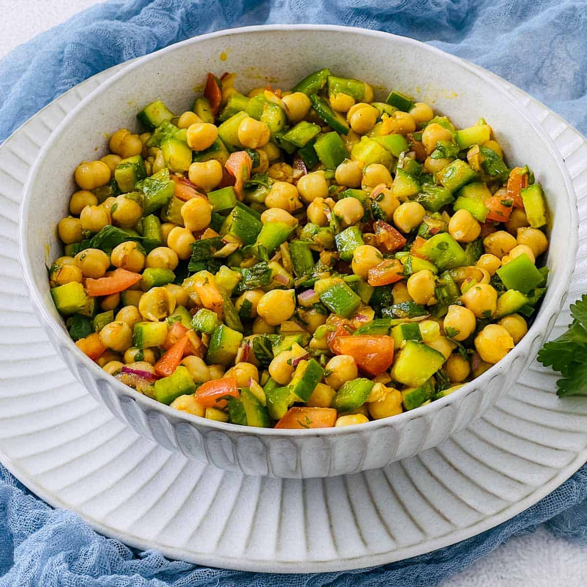 Moroccan chickpea salad garnished with cilantro and mint.