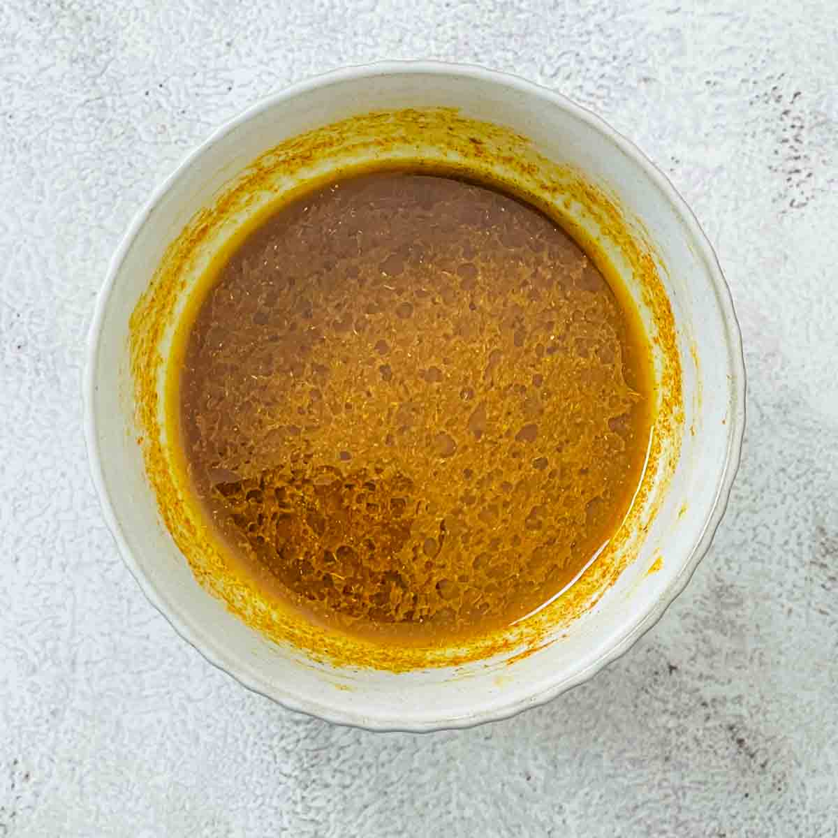 Salad dressing in a small bowl.