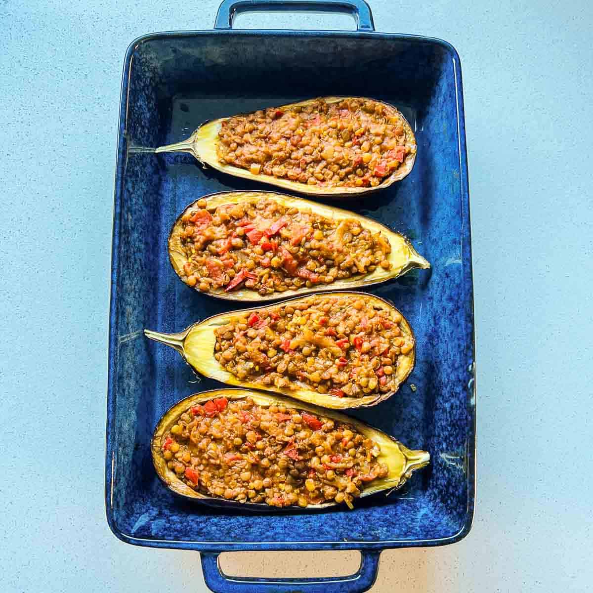 Prepared lentils filled into baked eggplants.