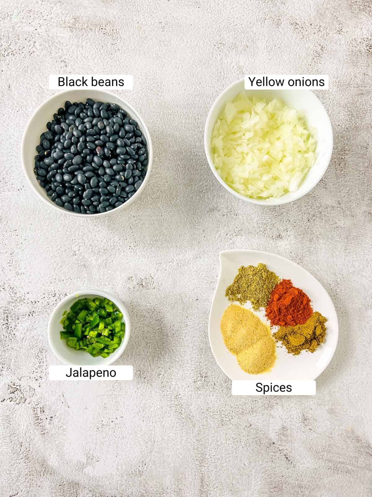 Ingredients to make refried beans on a white surface.