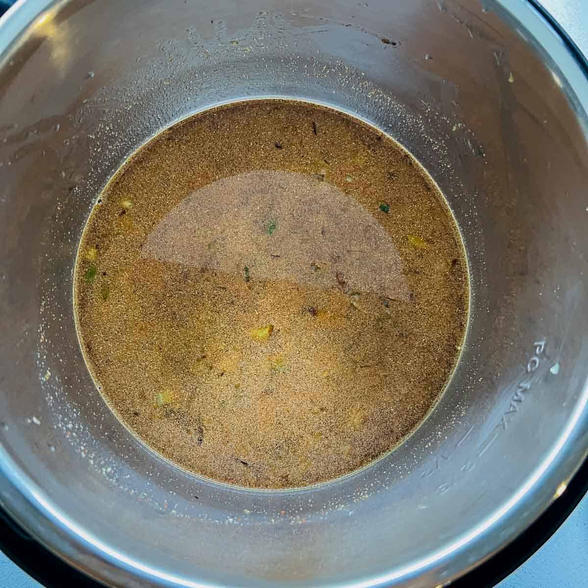 Black beans, spices, and water in Instant Pot.