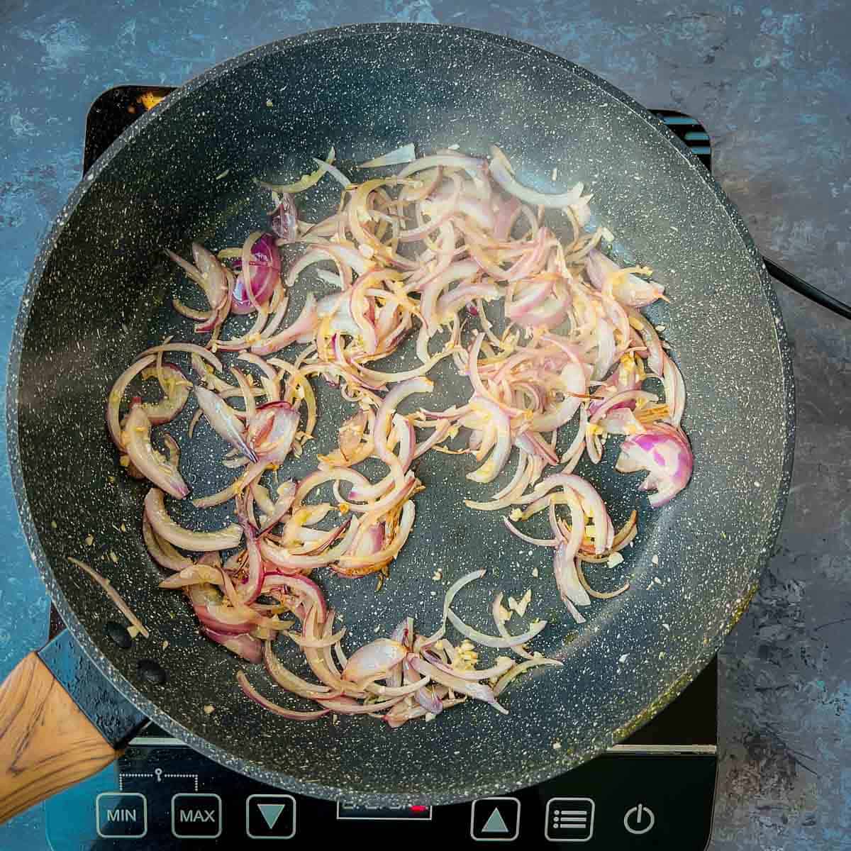 Sauted onion and garlic in frying pan.