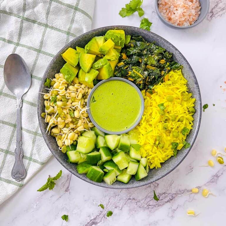 Green goddess power bowl with a spoon in the background.