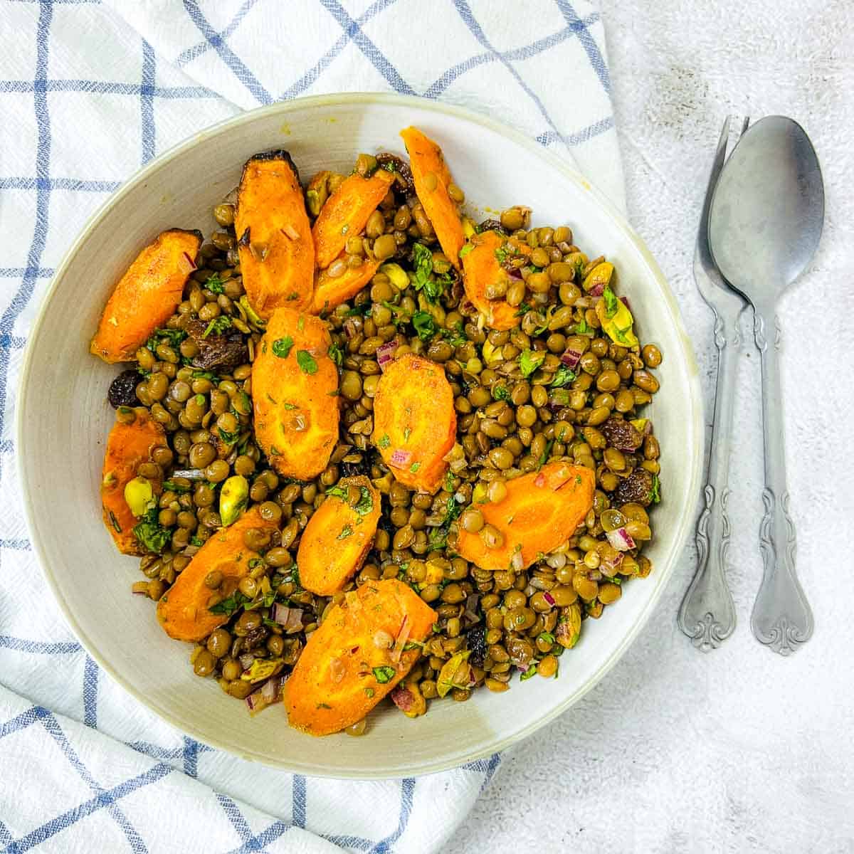 Moroccan lentil and carrot salad in white bowl.