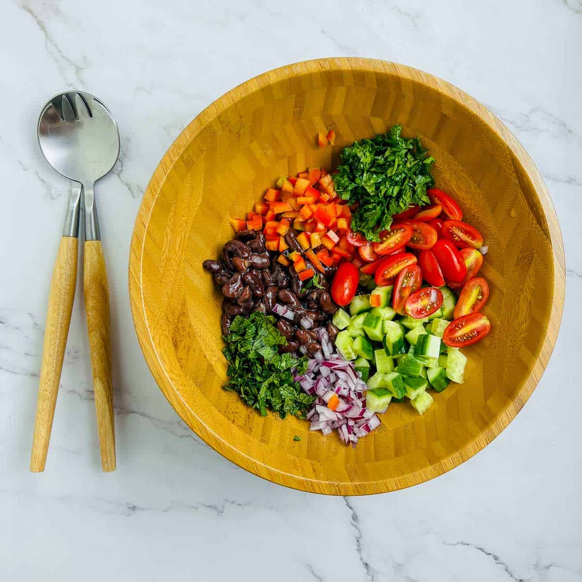 Veggies and beans in a mixing bowl.
