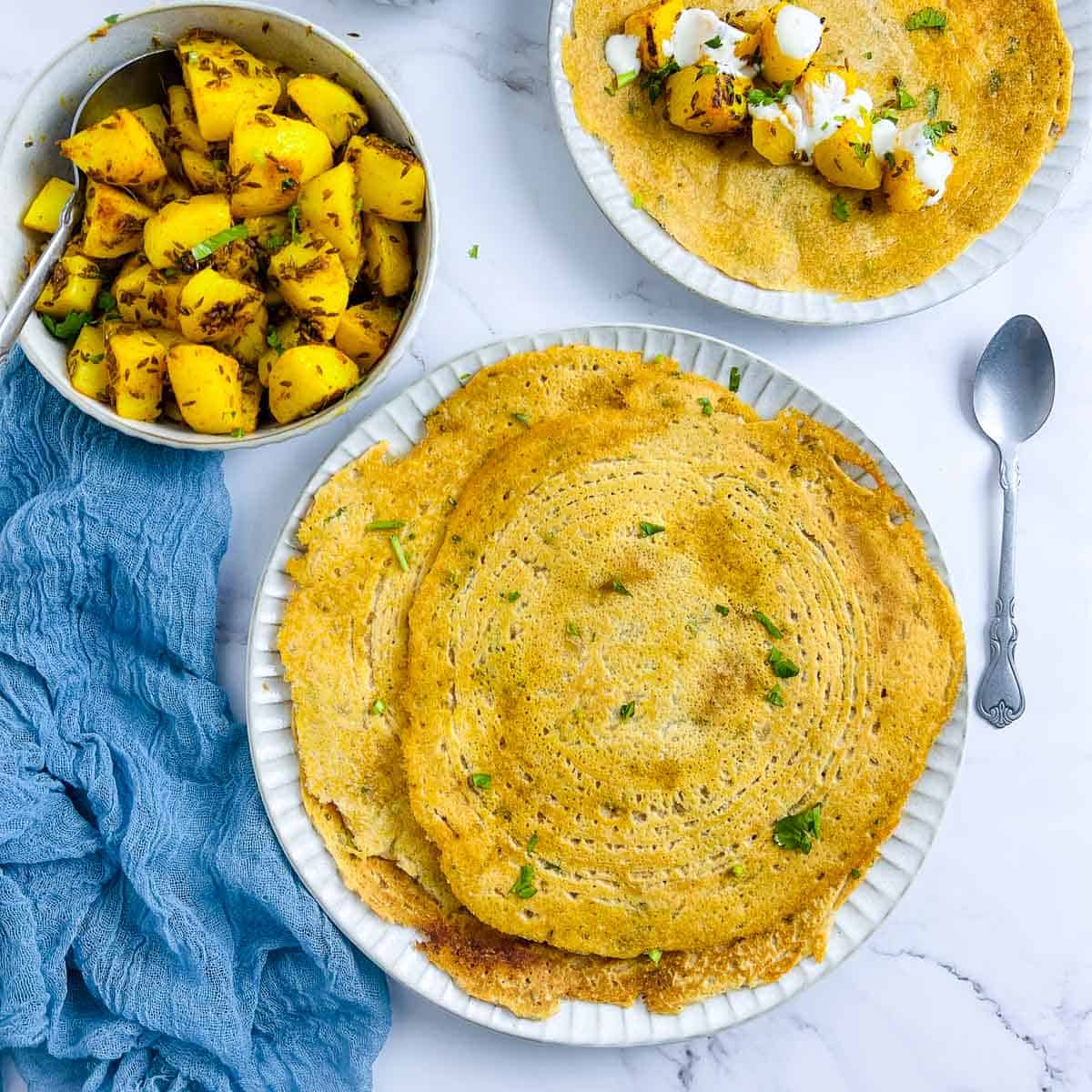 Red lentil pancakes served with cumin-flavored potatoes.