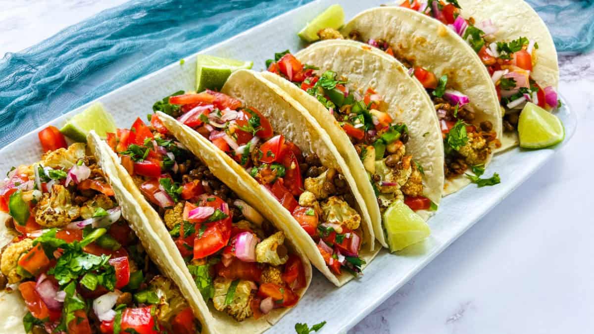 Cauliflower lentil tacos on a white plate.