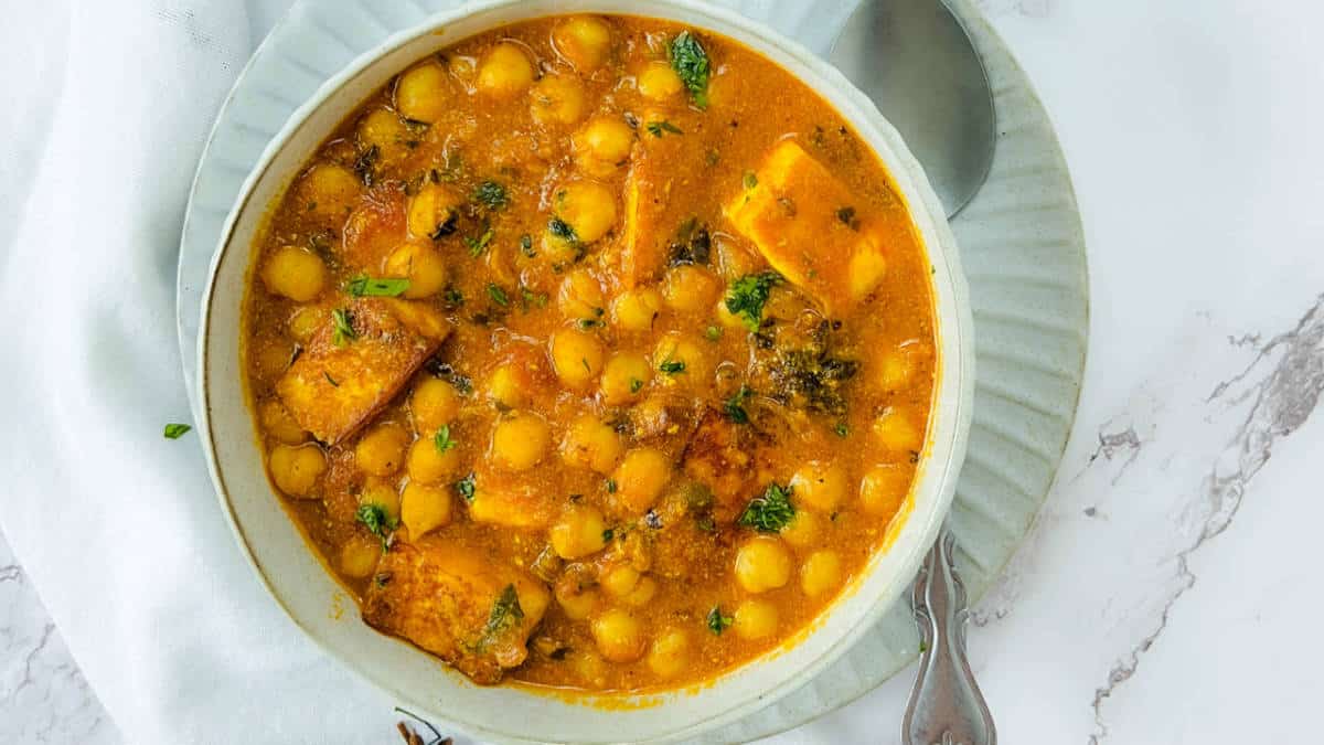 Chana paneer in a white bowl.