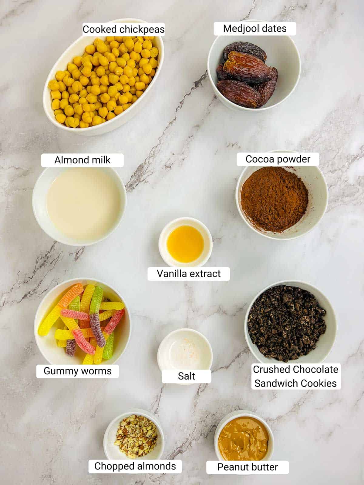 Ingredients to make dirt pudding on a marble surface.