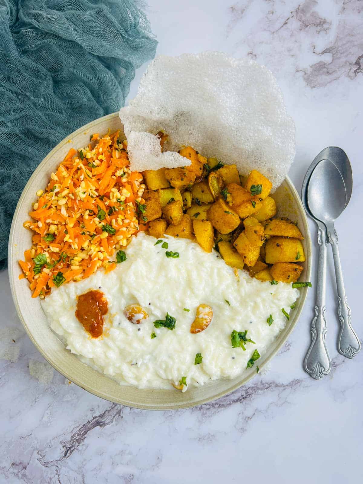 Curd rice bowl on a white surface.