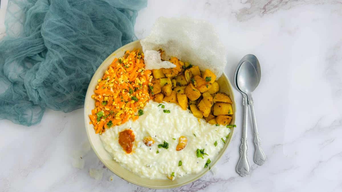 A bowl of curd rice, kosambari, and potato fry.