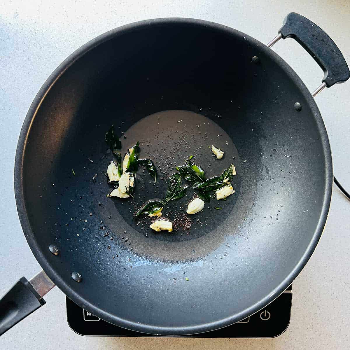 Garlic tempering in a frying pan.