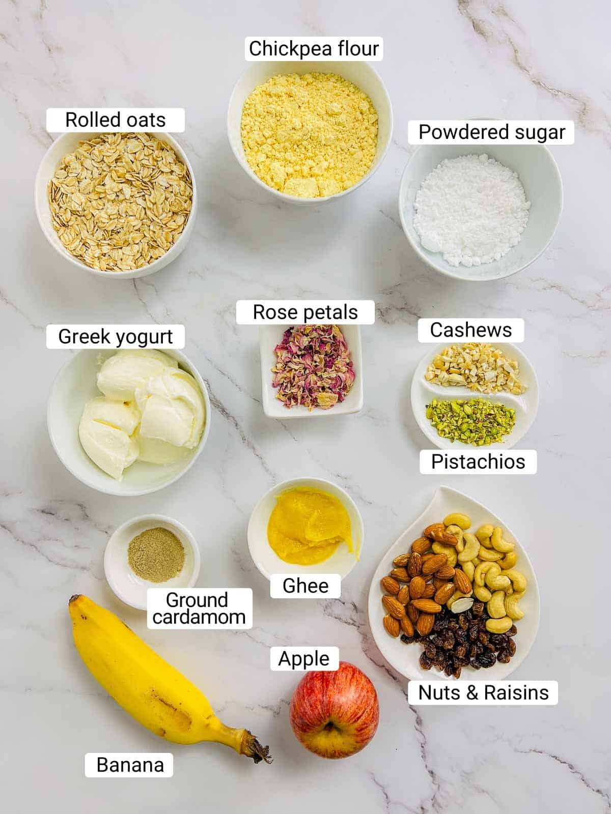 Ingredients to make Indian oatmeal breakfast bowl on a white surface.