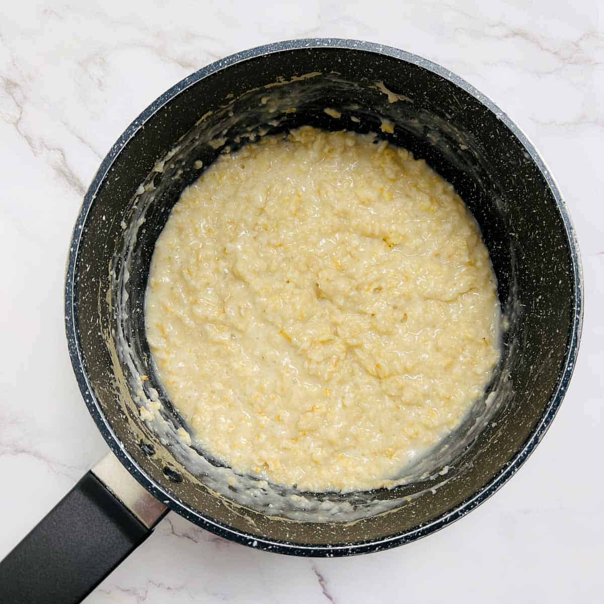 Cooked oats in a saucepan.