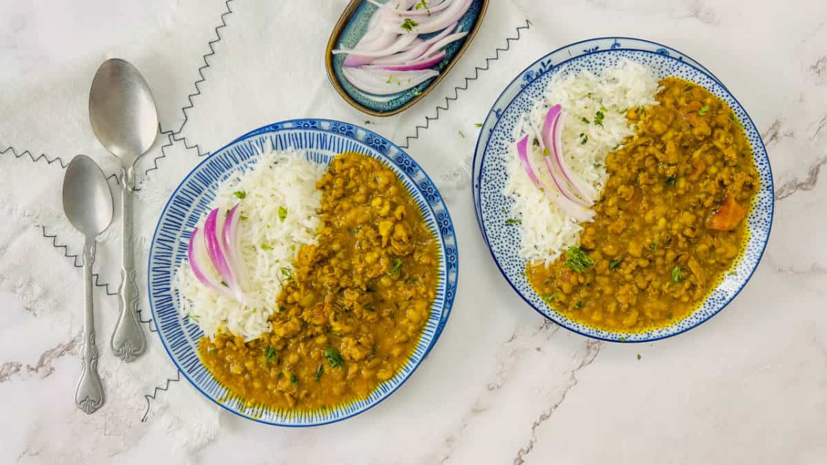 Keema moong dal served with rice in blue plates.
