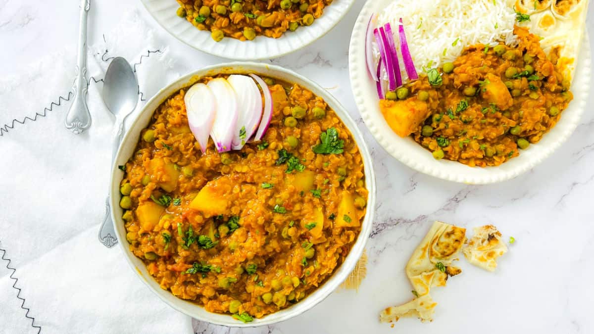 Red Lentils, Peas, & Potato Curry in a white bowl.