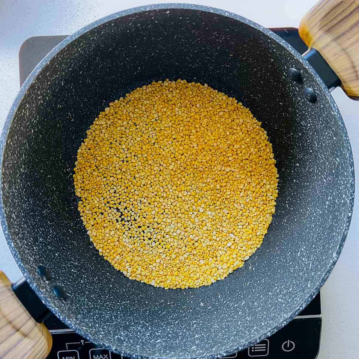 Roasted moong dal in a pan.