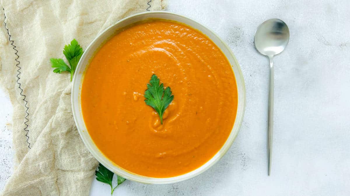 Tomato lentil soup topped with parsley.