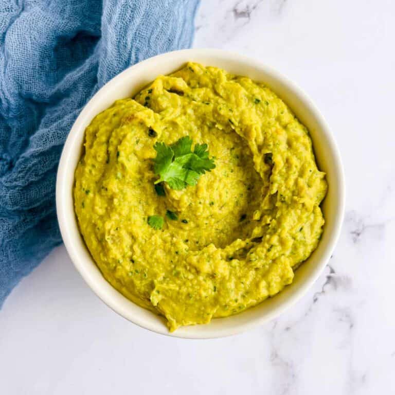 Curried bean dip served in a small white bowl.