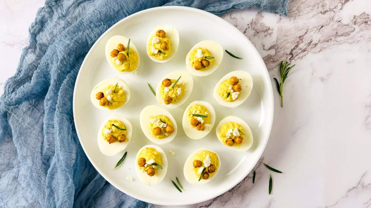 Chickpea deviled eggs on a white plate.