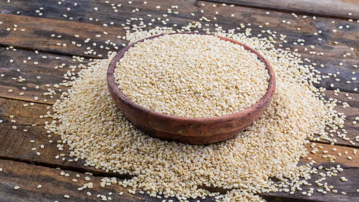 Urad dal in a small wooden bowl.