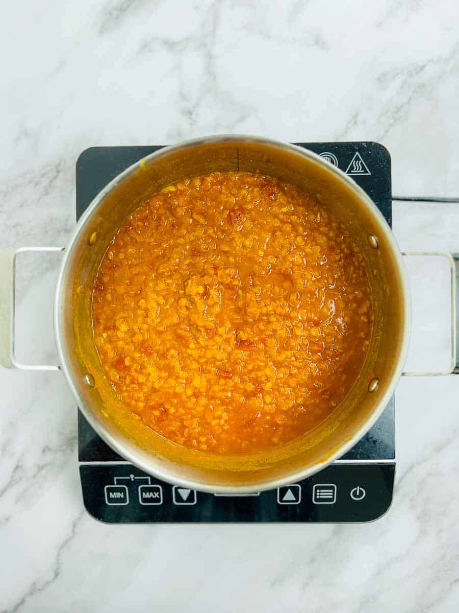 Cooked red lentils in the pot.