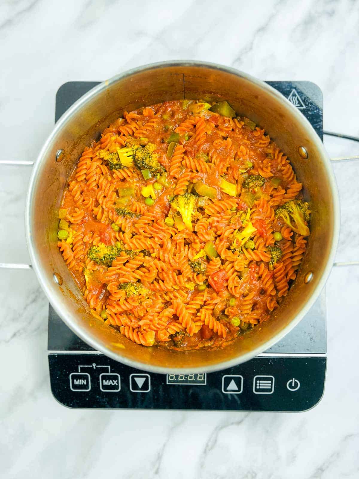 Red lentil pasta cooked with vegetables and tomato base.