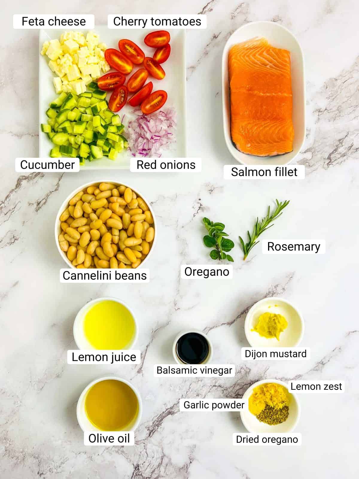 Ingredients to make salmon and white bean salad on a white surface.