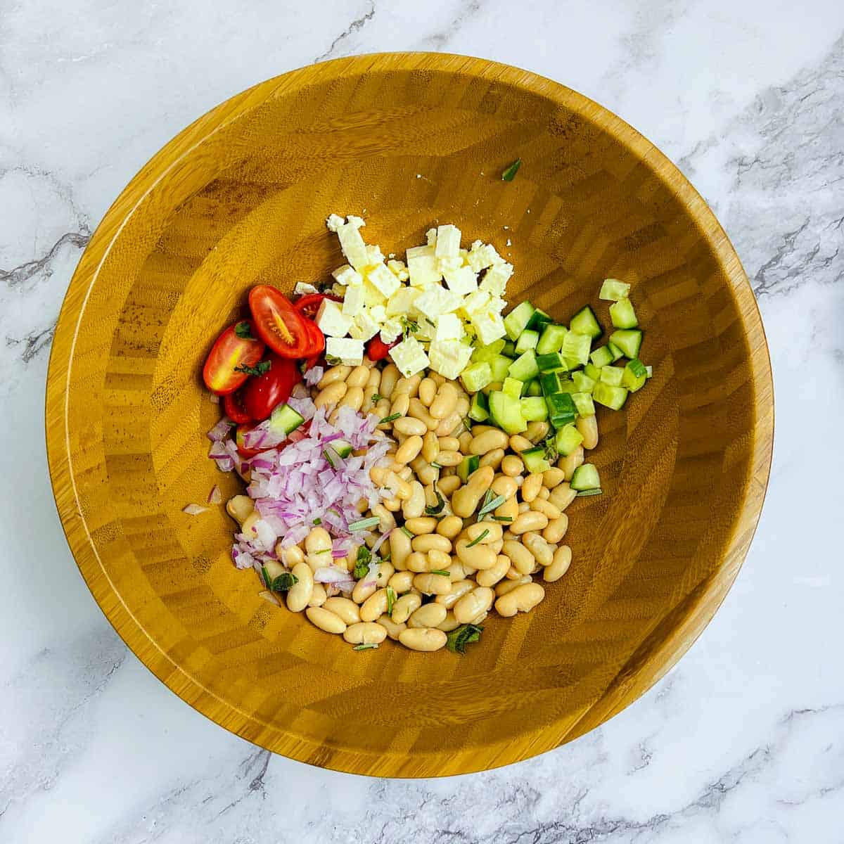Veggies and beans in a mixing bowl.