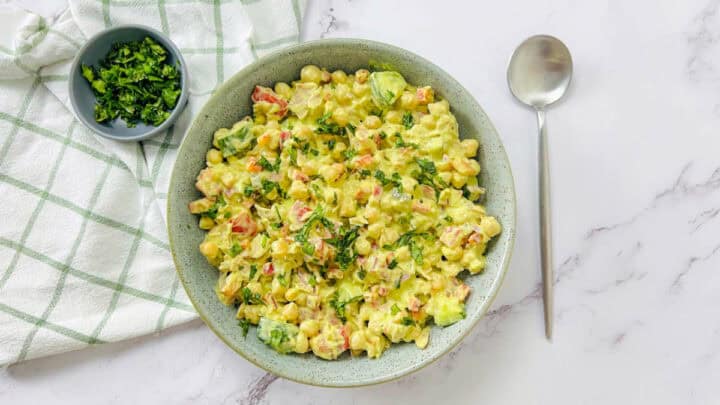 Tuna chickpea salad in a green bowl.