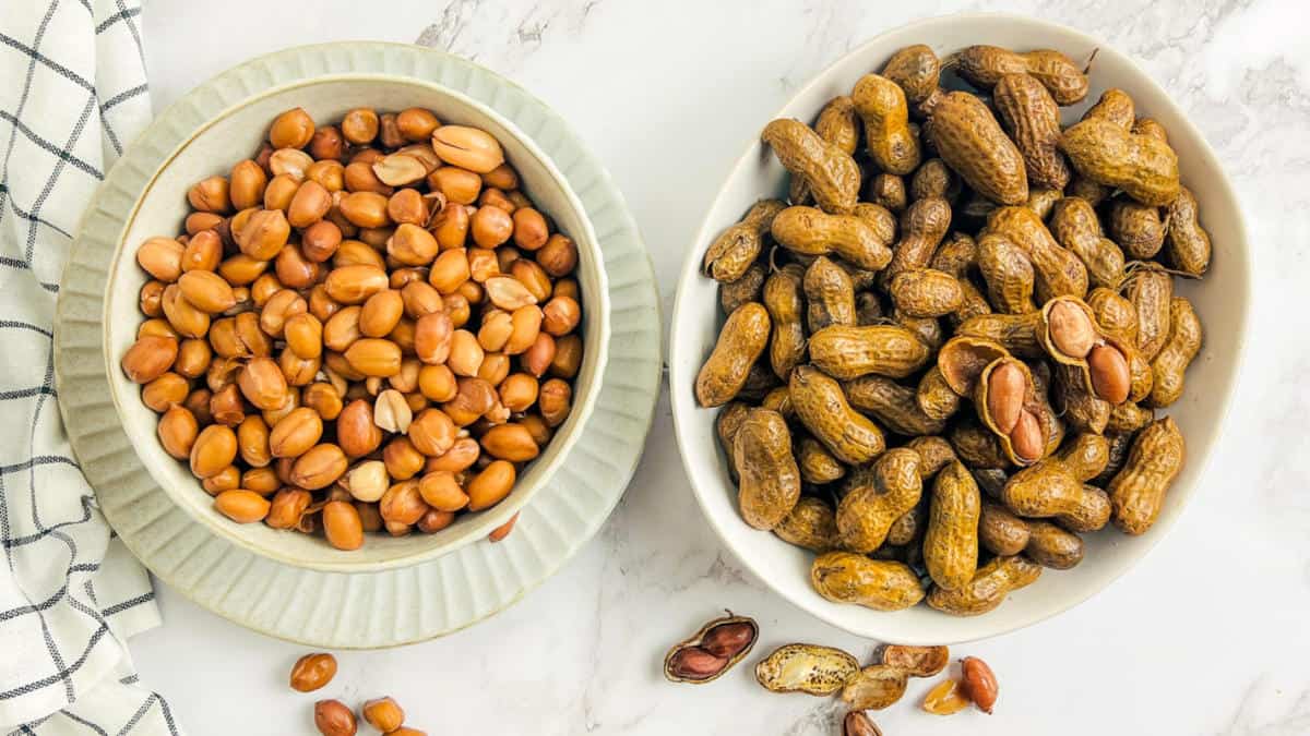 Shelled and unshelled boiled peanuts in separate bowls.
