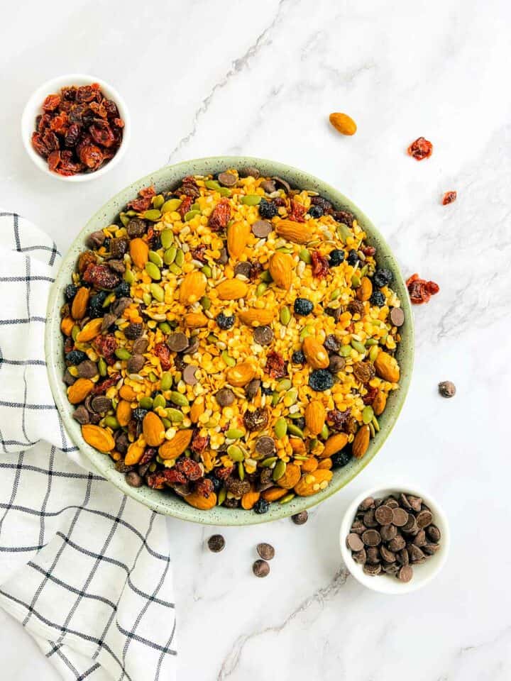 Lentil trail mix in a wide green bowl.