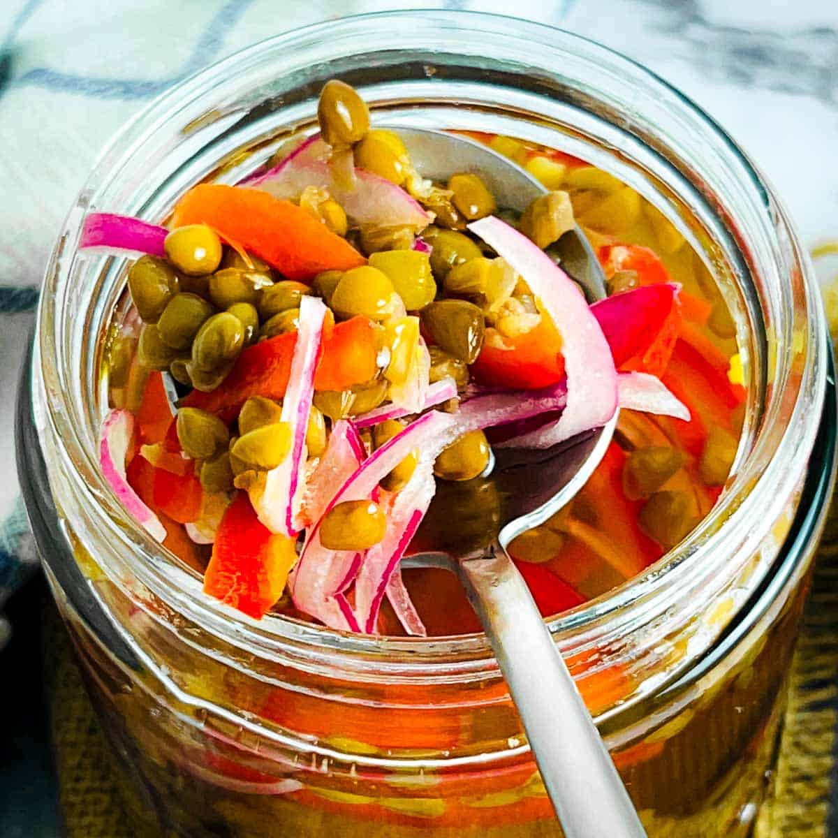 Pickled lentils on a spoon.