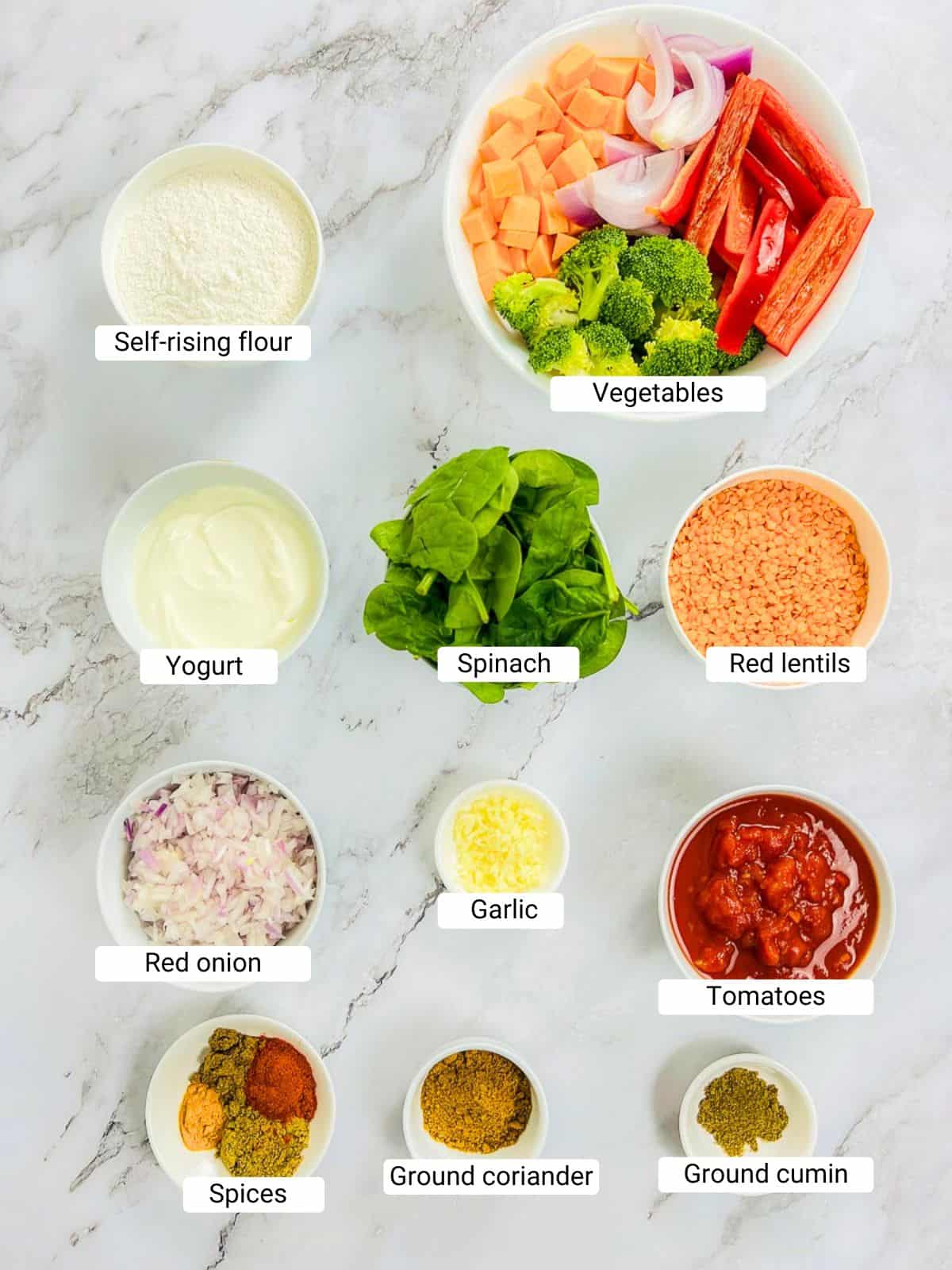 Ingredients to make the Buddha bowl on a marble surface.
