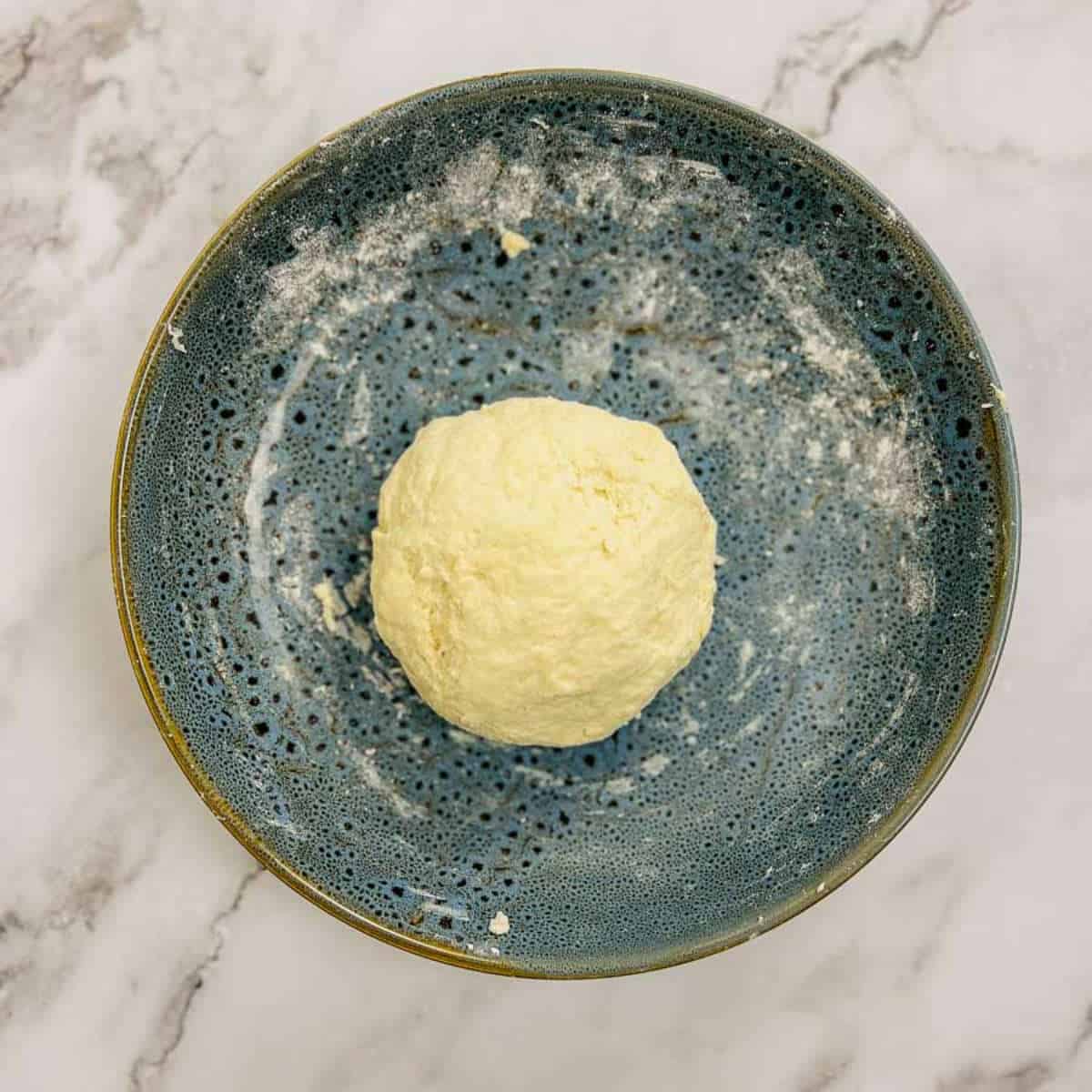 2-ingredient naan dough in a wide bowl.