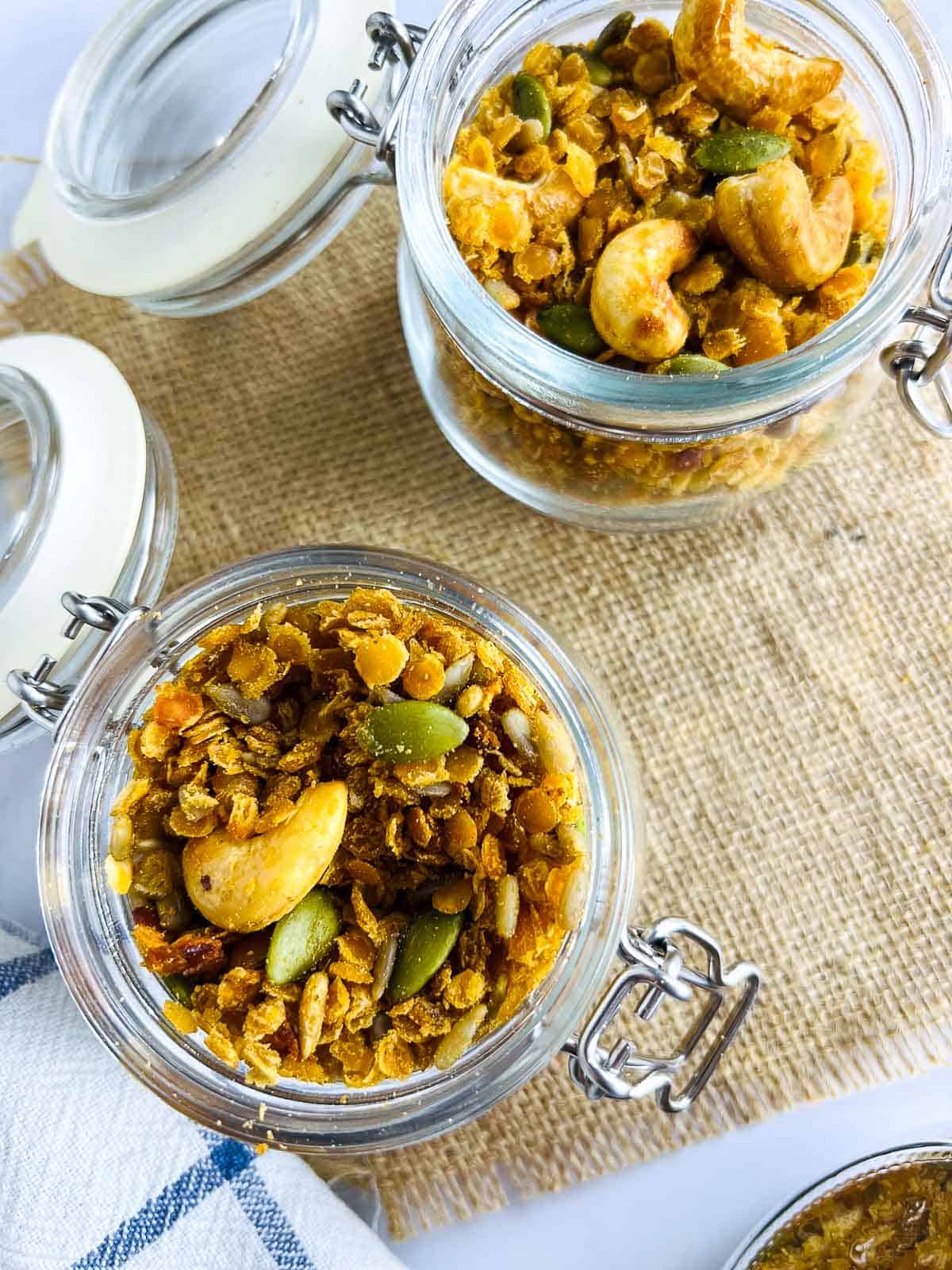 Red lentil granola stored in two glass jars.