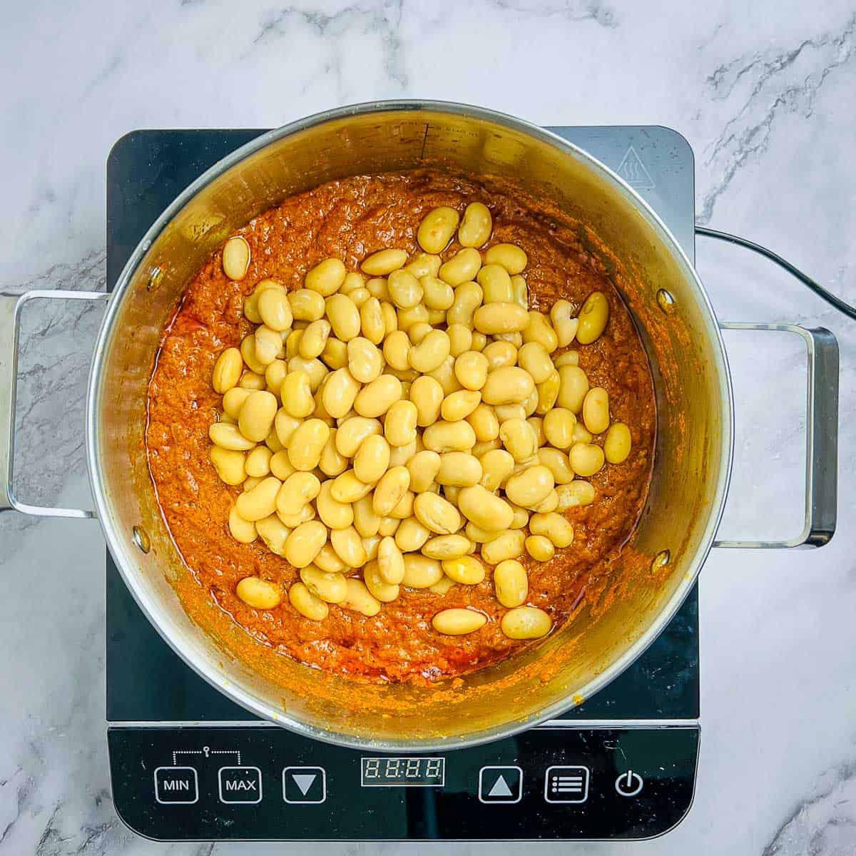 Yogurt cooked in onion-tomato curry masala and then butter beans added.