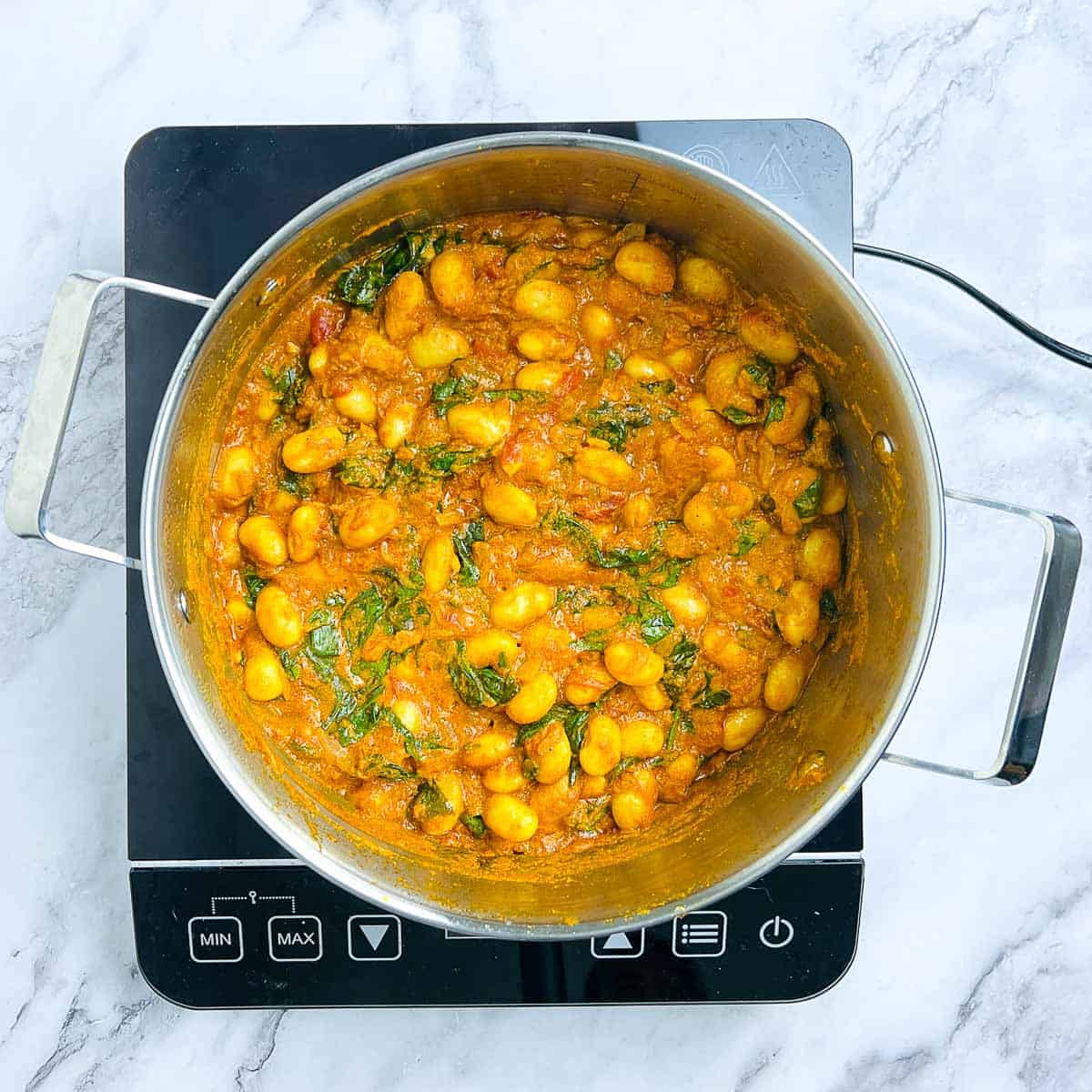 Butter beans and spinach cooked in the curry sauce.